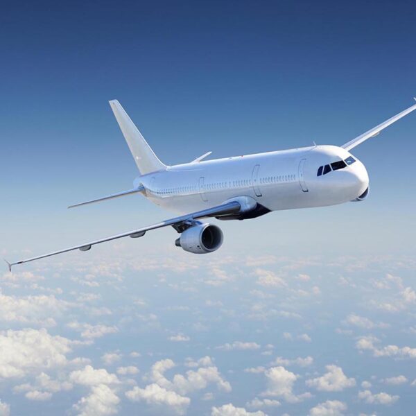 Airplane in the sky, over the cloudy sky